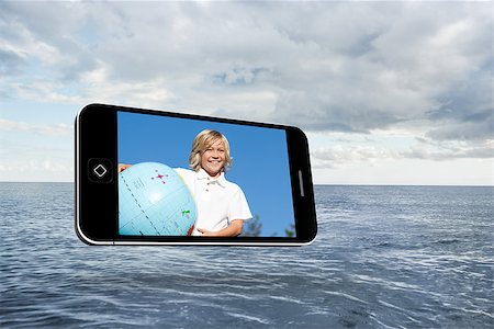 Blonde happy boy on smartphone screen against cloudy sky and ocean Stock Photo - Budget Royalty-Free & Subscription, Code: 400-07448823