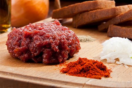 steak tartare - Steak tartar ready to eat on the wooden trencher Stock Photo - Budget Royalty-Free & Subscription, Code: 400-07449103