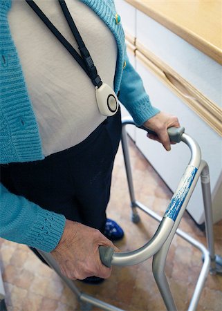 sos image - Old lady walking with the aid of a walking frame and wearing  a personal alarm. Stock Photo - Budget Royalty-Free & Subscription, Code: 400-07449253