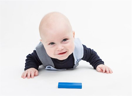 interested baby with toy block on floor isolated on white Foto de stock - Royalty-Free Super Valor e Assinatura, Número: 400-07449522