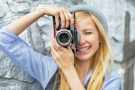 simsearch:400-08194027,k - Portrait of young hipster taking photo with retro photo camera Photographie de stock - Aubaine LD & Abonnement, Code: 400-07450311