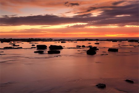 simsearch:400-07667033,k - For a brief few minutes the pre sunrise sky was full of fiery colours.  Bateau Bay rock shelf at high tide Stock Photo - Budget Royalty-Free & Subscription, Code: 400-07464486
