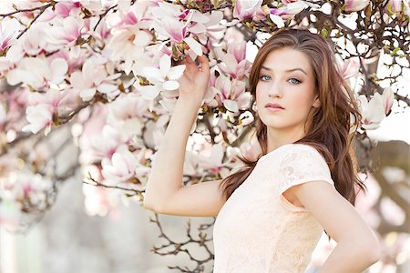 beautiful smiling woman and pink magnolia outside in spring Stock Photo - Budget Royalty-Free & Subscription, Code: 400-07464730