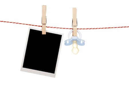 Instant photo and pacifier hanging on the clothesline. Isolated on white background Stock Photo - Budget Royalty-Free & Subscription, Code: 400-07465118