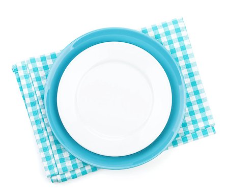 Empty plates over kitchen towel. Isolated on white background Stock Photo - Budget Royalty-Free & Subscription, Code: 400-07465158