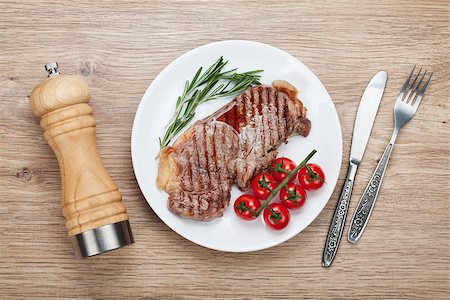 steak knife - Sirloin steak with rosemary and cherry tomatoes on a plate. View from above Stock Photo - Budget Royalty-Free & Subscription, Code: 400-07465195