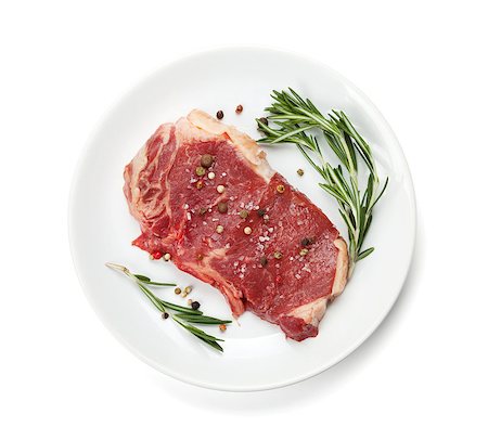 steak and fries - Raw sirloin steak with rosemary and spices on plate. Isolated on white background Photographie de stock - Aubaine LD & Abonnement, Code: 400-07465193