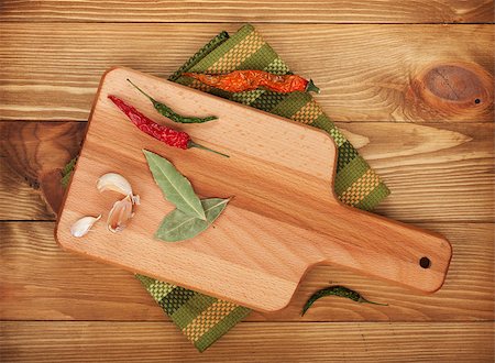 Herbs and spices on cutting board over wooden table background Photographie de stock - Aubaine LD & Abonnement, Code: 400-07465206