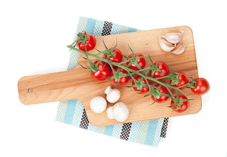 Cherry tomatoes with mushrooms and garlic on cutting board. View from above. Isolated on white Foto de stock - Super Valor sin royalties y Suscripción, Código: 400-07465230