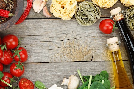 Fresh ingredients for cooking: pasta, tomato and spices over wooden table background with copy space Stock Photo - Budget Royalty-Free & Subscription, Code: 400-07465248