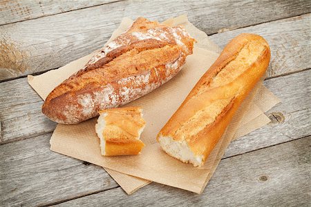 simsearch:400-06416084,k - French bread over wooden table background Photographie de stock - Aubaine LD & Abonnement, Code: 400-07465253