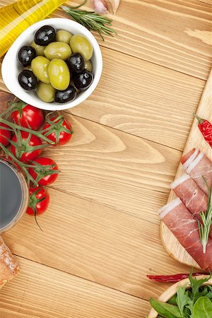 simsearch:400-07481826,k - Red wine with olives, tomatoes, prosciutto, bread and spices. Over wooden table background. View from above with copy space Stock Photo - Budget Royalty-Free & Subscription, Code: 400-07465266