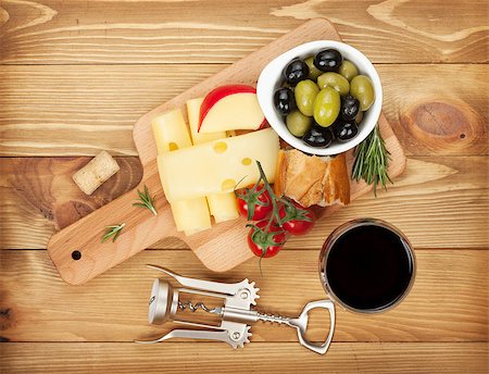 Red wine with cheese, bread, olives and spices. Over wooden table background. View from above Stock Photo - Budget Royalty-Free & Subscription, Code: 400-07465272