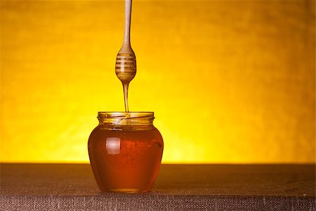 simsearch:400-06640106,k - Honey jar with wooden dipper and flowing honey, studio shot Stock Photo - Budget Royalty-Free & Subscription, Code: 400-07465492