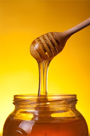 simsearch:400-06640106,k - Close-up shot of wooden dipper with flowing honey over yellow background Stock Photo - Budget Royalty-Free & Subscription, Code: 400-07465493