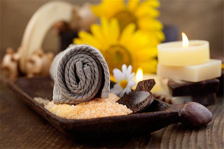 spa background - Spa and wellness setting with natural bath salt, candles and towel, massager and sunflower.. Brown dayspa nature set with copyspace Stock Photo - Budget Royalty-Free & Subscription, Code: 400-07465865