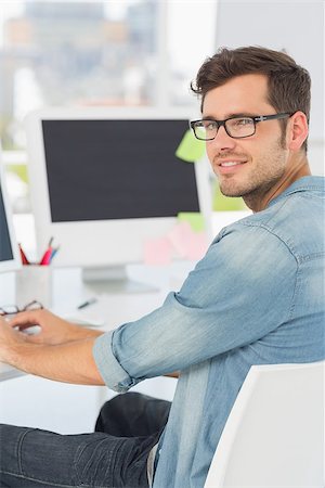 editor designer - Side view portrait of a male artist using computer in the office Stock Photo - Budget Royalty-Free & Subscription, Code: 400-07466444