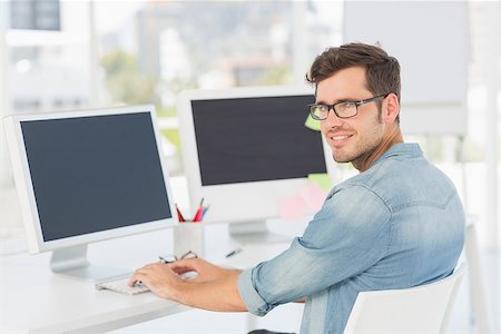 editor designer - Side view portrait of a male artist using computer in the office Stock Photo - Budget Royalty-Free & Subscription, Code: 400-07466443