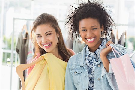 Portrait of two happy young women with shopping bags in the clothes store Stock Photo - Budget Royalty-Free & Subscription, Code: 400-07466613