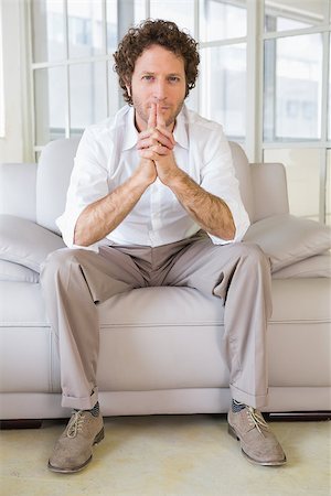 simsearch:400-07274613,k - Portrait of a relaxed young man sitting on sofa in the house Stock Photo - Budget Royalty-Free & Subscription, Code: 400-07466625