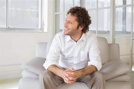 simsearch:400-07274613,k - Relaxed smiling well dressed man sitting on sofa in the house Stock Photo - Budget Royalty-Free & Subscription, Code: 400-07466647