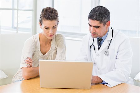 photo of patient in hospital in usa - Male doctor and patient using laptop at desk in medical office Stock Photo - Budget Royalty-Free & Subscription, Code: 400-07466739