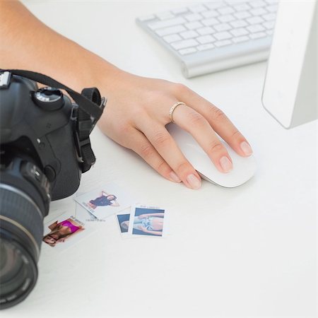 Digital camera on photographers desk with womans hand on mouse in creative office Stock Photo - Budget Royalty-Free & Subscription, Code: 400-07466832