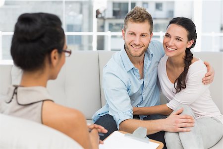 Smiling couple reconciling at therapy session in therapists office Stock Photo - Budget Royalty-Free & Subscription, Code: 400-07466946