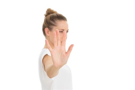 Woman holding her hand up to the camera on white background Stock Photo - Budget Royalty-Free & Subscription, Code: 400-07466997