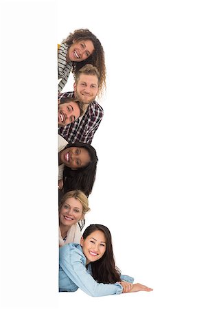 peeping fashion - Happy group of young friends peeking from behind a wall on white background Photographie de stock - Aubaine LD & Abonnement, Code: 400-07467162