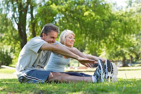 fitness   mature woman - Happy couple stretching while sitting on grass in the park Stock Photo - Budget Royalty-Free & Subscription, Code: 400-07467382