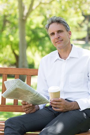 Portrait of businessman with disposable cup and newspaper in the park Stock Photo - Budget Royalty-Free & Subscription, Code: 400-07467407