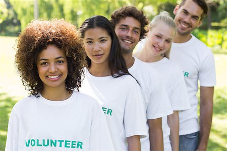 simsearch:400-07273325,k - Portrait of confident young volunteers standing in a line at park Foto de stock - Royalty-Free Super Valor e Assinatura, Número: 400-07467630