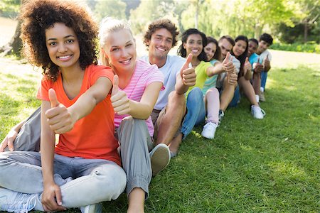 diversity in college campuses - Portrait of confident university students gesturing thumbs up while sitting on campus Stock Photo - Budget Royalty-Free & Subscription, Code: 400-07467684