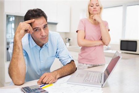 Worried couple with bills and laptop in the kitchen at home Stock Photo - Budget Royalty-Free & Subscription, Code: 400-07467776