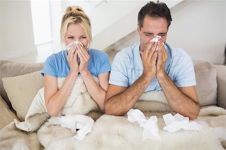 Couple suffering from cold as they sit on bed at home Stock Photo - Budget Royalty-Free & Subscription, Code: 400-07467933