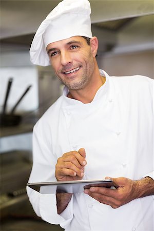 simsearch:400-07468062,k - Portrait of a smiling male cook using digital tablet in the kitchen Stockbilder - Microstock & Abonnement, Bildnummer: 400-07468055