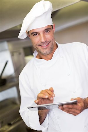 simsearch:400-07468062,k - Portrait of a smiling male cook using digital tablet in the kitchen Stockbilder - Microstock & Abonnement, Bildnummer: 400-07468056