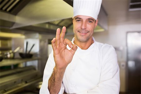 simsearch:400-07468062,k - Portrait of a smiling male cook gesturing okay sign in the kitchen Stockbilder - Microstock & Abonnement, Bildnummer: 400-07468051