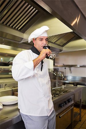 simsearch:400-09222970,k - Side view of a male cook drinking red wine in the kitchen Stock Photo - Budget Royalty-Free & Subscription, Code: 400-07468079