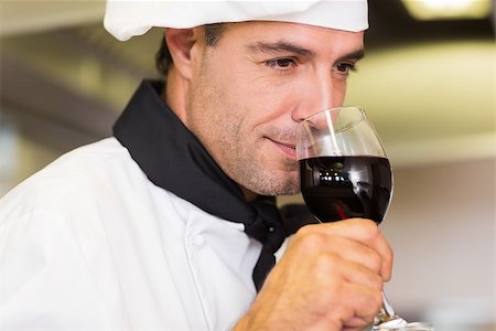simsearch:400-07468062,k - Closeup of a male chef smelling red wine in the kitchen Stockbilder - Microstock & Abonnement, Bildnummer: 400-07468081