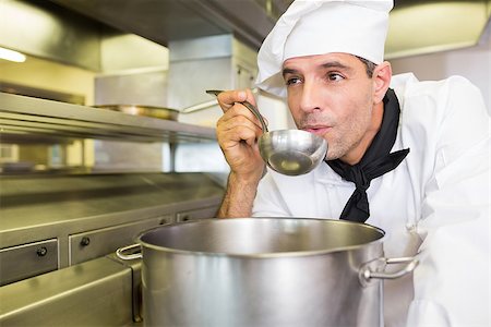 simsearch:400-07468062,k - Concentrated young male cook tasting food in the kitchen Stockbilder - Microstock & Abonnement, Bildnummer: 400-07468091