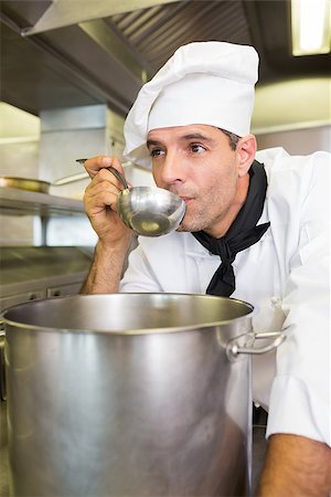 simsearch:400-07468062,k - Concentrated young male cook tasting food in the kitchen Stockbilder - Microstock & Abonnement, Bildnummer: 400-07468092