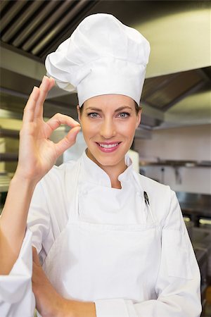 Portrait of a smiling female cook gesturing okay sign in the kitchen Stock Photo - Budget Royalty-Free & Subscription, Code: 400-07468135