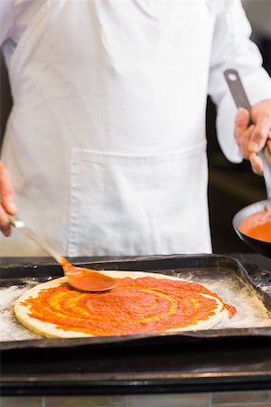 Closeup mid section of a male chef preparing pizza in kitchen Stock Photo - Budget Royalty-Free & Subscription, Code: 400-07468195