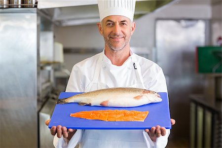 Portrait of a confidence male chef holding tray of raw fish in the kitchen Stock Photo - Budget Royalty-Free & Subscription, Code: 400-07468190