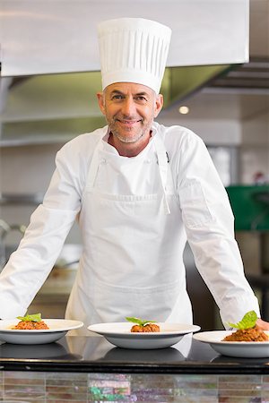 simsearch:400-07468062,k - Portrait of a confident male chef with cooked food standing in the kitchen Stockbilder - Microstock & Abonnement, Bildnummer: 400-07468218