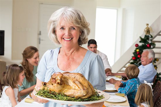 Portrait of happy grandmother with Christmas meal at dining table Stock Photo - Royalty-Free, Artist: 4774344sean, Image code: 400-07468432