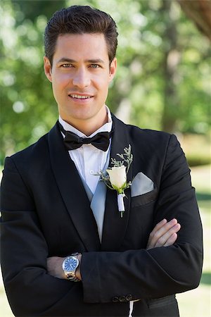 Portrait of confident groom with arms crossed standing in garden Stock Photo - Budget Royalty-Free & Subscription, Code: 400-07468470