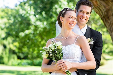 simsearch:400-07473236,k - Happy young groom and bride standing in garden Stockbilder - Microstock & Abonnement, Bildnummer: 400-07468514